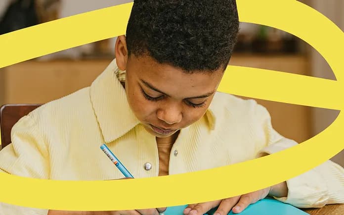 Student focused on writing in a notebook